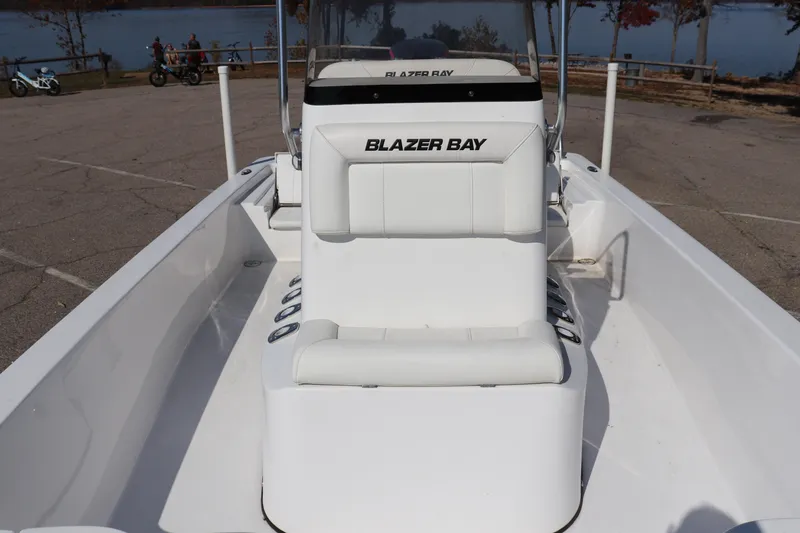 Slide: The Image of 2024 Blazer Bay 2220 Fisherman boat interior with white seating and console. - 5