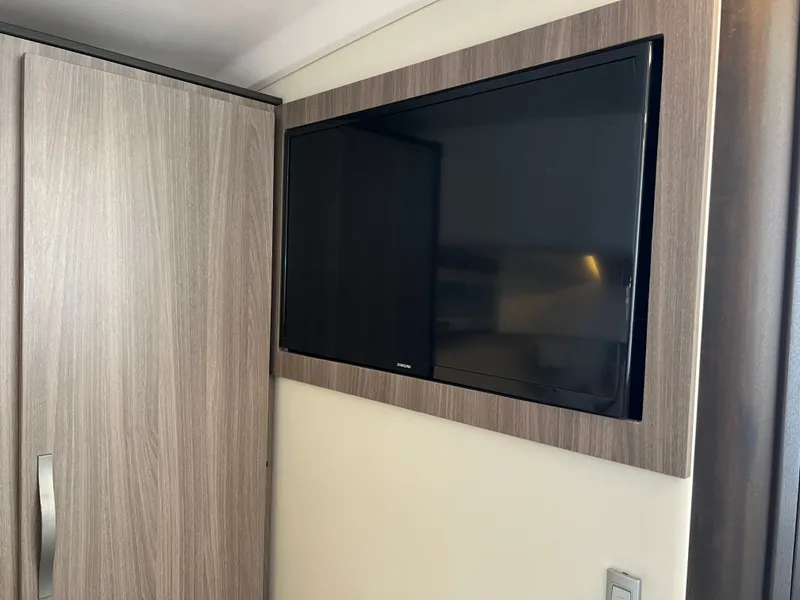 Slide: The Image of 2022 Regal 36GC boat with "Oversize Load" sign, parked under cloudy sky. - 4