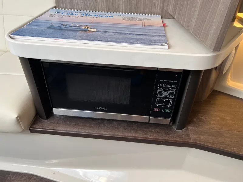 Slide: The Image of 2022 Regal 36GC boat with spacious deck and custom name "Stork & Tort." - 7