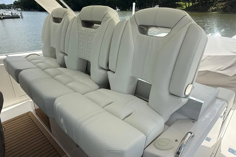 Slide: The Image of Luxurious seating on 2024 Tiara Yachts 38 LS, featuring plush, modern design with scenic water backdrop. - 15