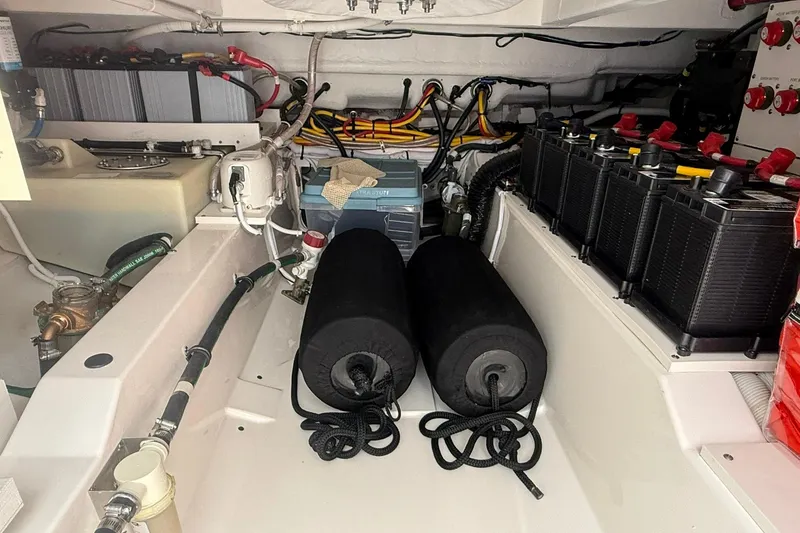 Slide: The Image of Engine compartment of 2024 Tiara Yachts 38 LS, featuring batteries and wiring. - 18