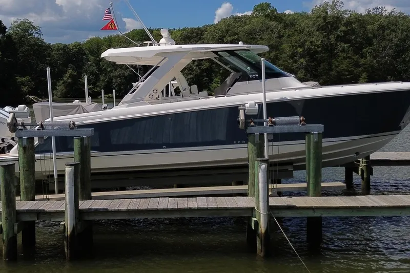 Slide: The Image of 2024 Tiara Yachts 38 LS docked, featuring sleek design and modern amenities. - 2