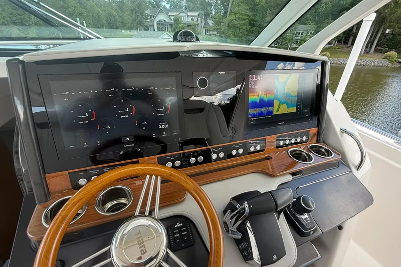 Slide: The Image of 2024 Tiara Yachts 38 LS helm with advanced navigation displays and controls. - 23