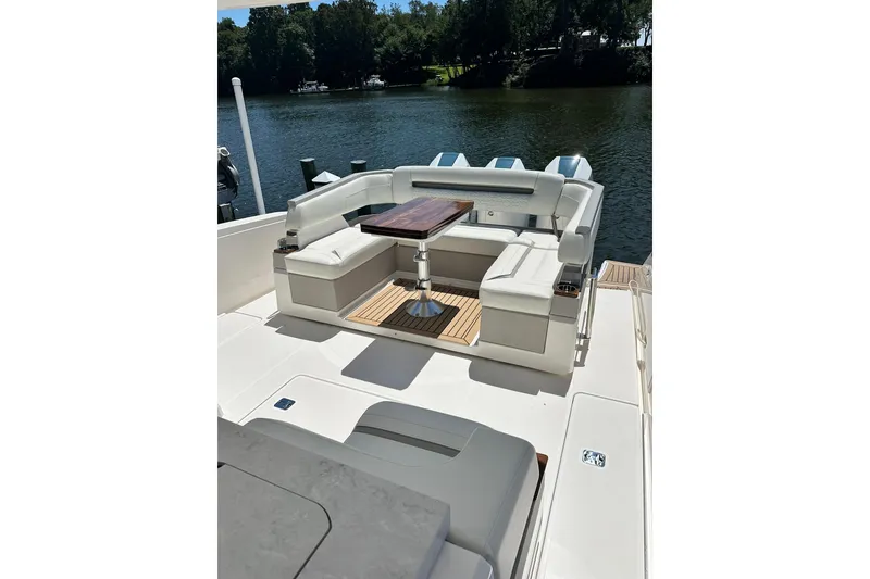 Slide: The Image of 2024 Tiara Yachts 38 LS luxury boat with elegant seating and wooden table on deck. - 26