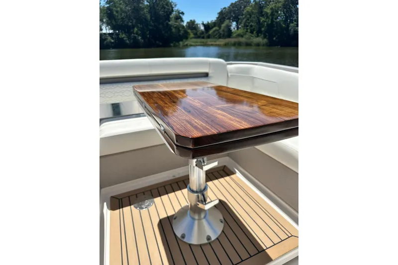 Slide: The Image of Luxurious wooden table on 2024 Tiara Yachts 38 LS, with scenic water view. - 27