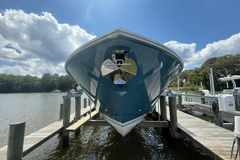 Slide: The Image of 2024 Tiara Yachts 38 LS docked, showcasing sleek design under a partly cloudy sky. - 3