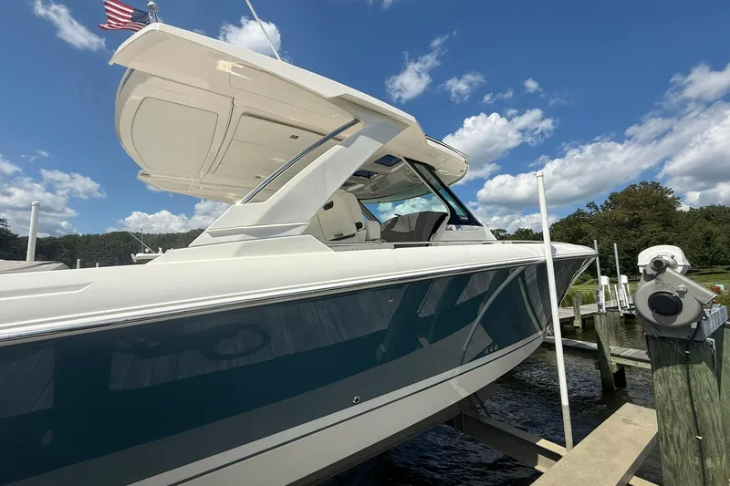 Slide: The Image of 2024 Tiara Yachts 38 LS docked, showcasing sleek design and modern features under a blue sky. - 5