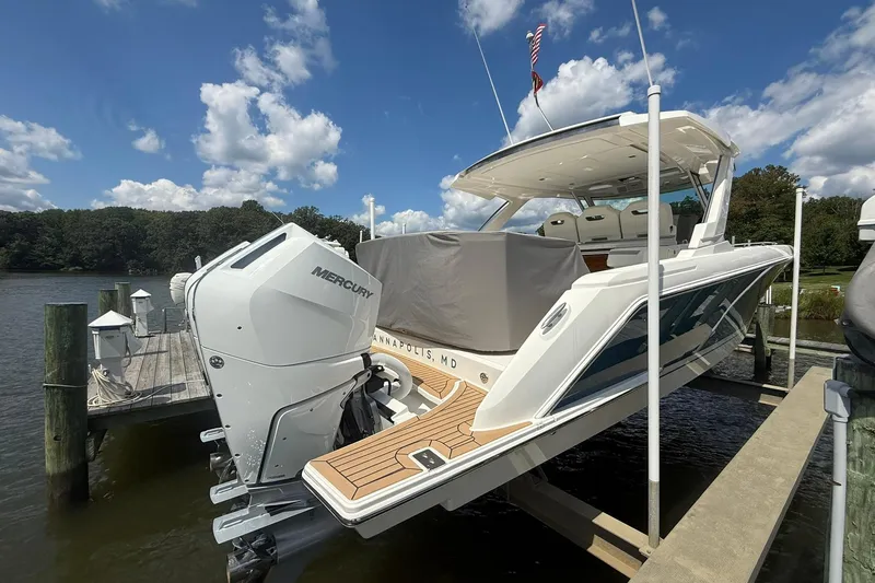 Slide: The Image of 2024 Tiara Yachts 38 LS docked, featuring powerful Mercury outboard engines under a clear sky. - 6