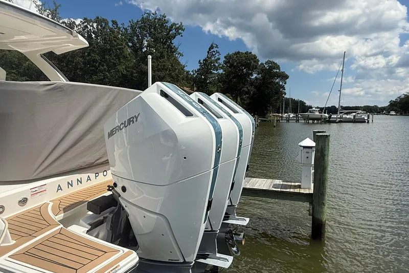 Slide: The Image of 2024 Tiara Yachts 38 LS with Mercury engines docked by a scenic waterfront. - 7