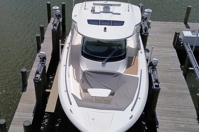 Slide: The Image of 2024 Tiara Yachts 38 LS docked, aerial view showcasing sleek design and modern features. - 8