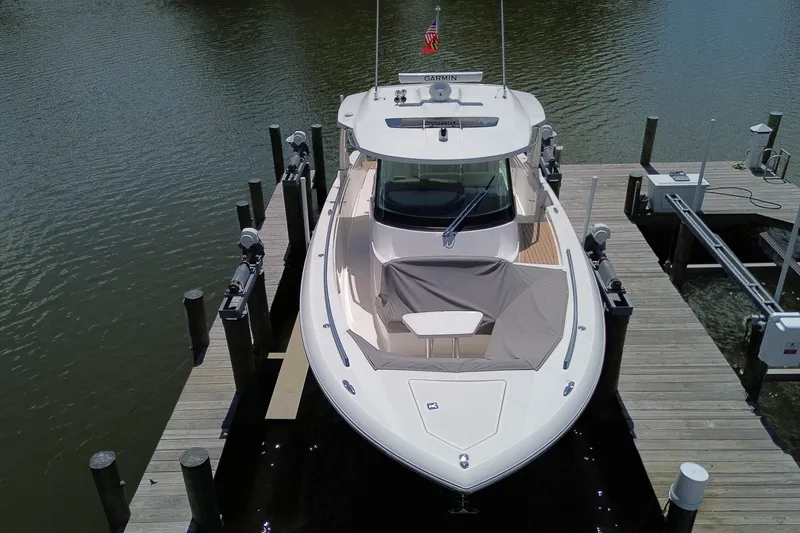 Slide: The Image of 2024 Tiara Yachts 38 LS docked, aerial view showcasing sleek design and spacious deck. - 9