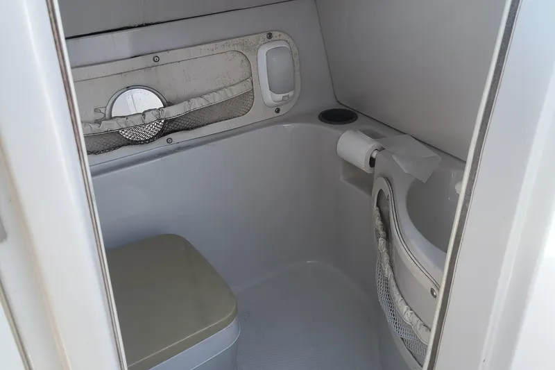 Slide: The Image of Compact bathroom in 2005 Tahoe 254 boat with toilet and sink. - 12