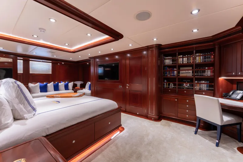 Slide: The Image of Luxurious yacht interior with elegant wood paneling, cozy seating, and a well-equipped study area. - 22