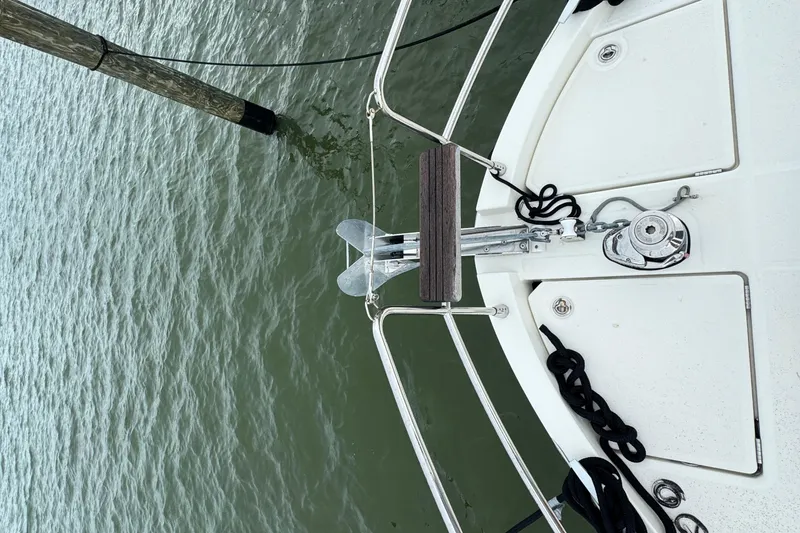 Slide: The Image of Bow of 2023 Beneteau Swift Trawler 35 with anchor and railing over water. - 15