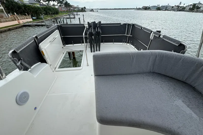 Slide: The Image of 2023 Beneteau Swift Trawler 35 deck with seating, overlooking waterfront view. - 28