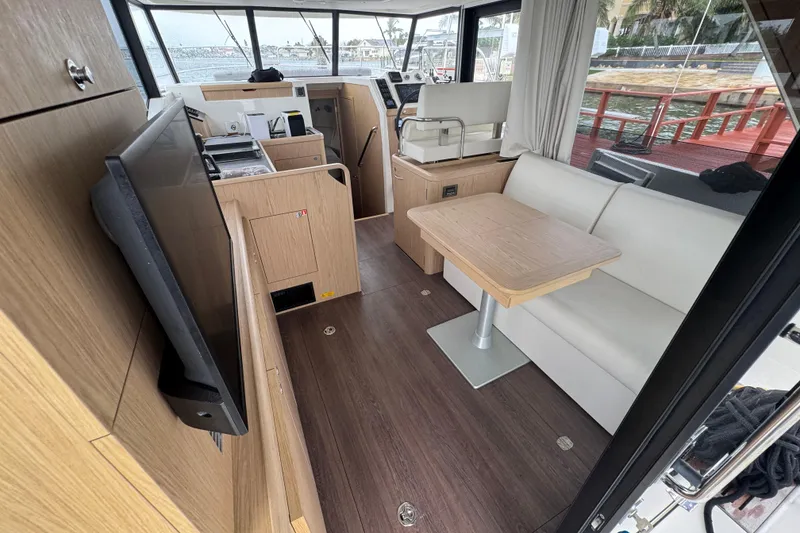 Slide: The Image of 2023 Beneteau Swift Trawler 35 interior with modern seating and navigation area. - 30