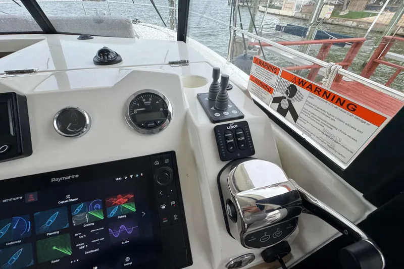 Slide: The Image of Control panel of 2023 Beneteau Swift Trawler 35 with navigation and warning signs. - 34