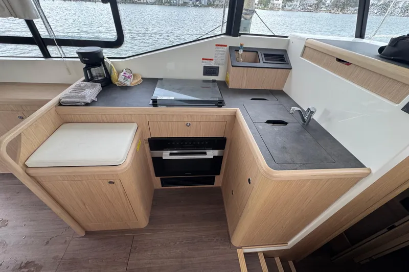Slide: The Image of Modern kitchen area in 2023 Beneteau Swift Trawler 35 with sleek design and appliances. - 37