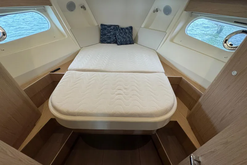 Slide: The Image of 2023 Beneteau Swift Trawler 35 cabin with cozy bed and nautical decor. - 39