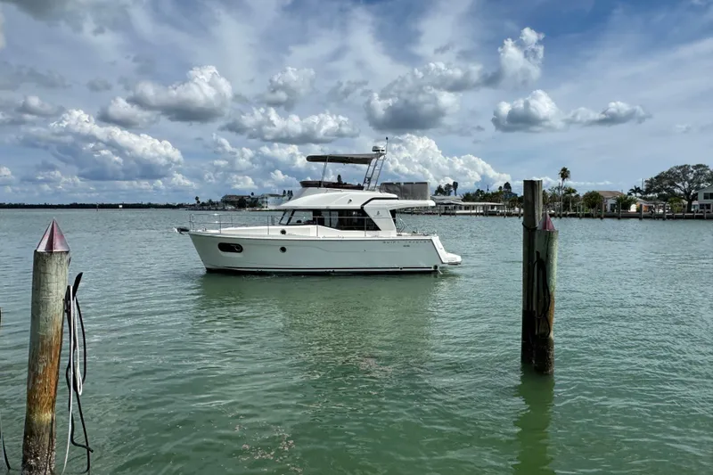 Slide: The Image of 2023 Beneteau Swift Trawler 35 on calm water under cloudy sky. - 4