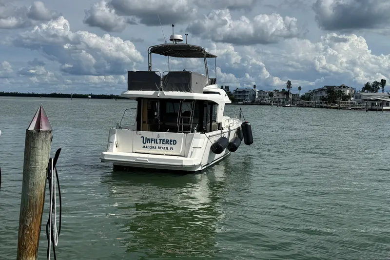 Slide: The Image of 2023 Beneteau Swift Trawler 35 on water near Madeira Beach, Florida, under cloudy sky. - 8