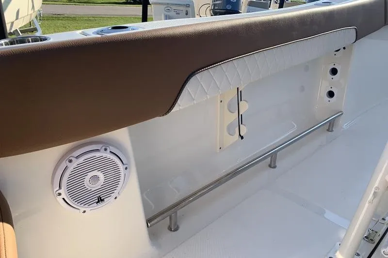 Slide: The Image of Interior of 2026 Pioneer ISLANDER 202 boat with speaker and cushioned seating. - 14