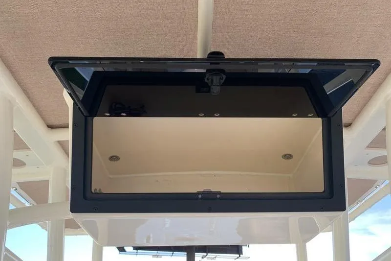 Slide: The Image of Open storage compartment on 2026 Pioneer ISLANDER 202 boat, showcasing interior space. - 16