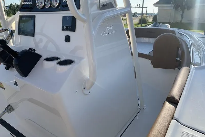 Slide: The Image of 2026 Pioneer ISLANDER 202 boat interior with steering console and seating area. - 21