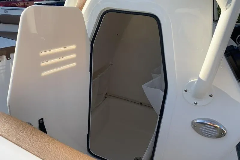 Slide: The Image of 2026 Pioneer ISLANDER 202 boat interior cabin with open door, showcasing sleek design. - 23