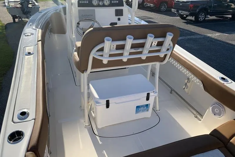 Slide: The Image of 2026 Pioneer ISLANDER 202 boat interior with seating, cooler, and rod holders. - 24