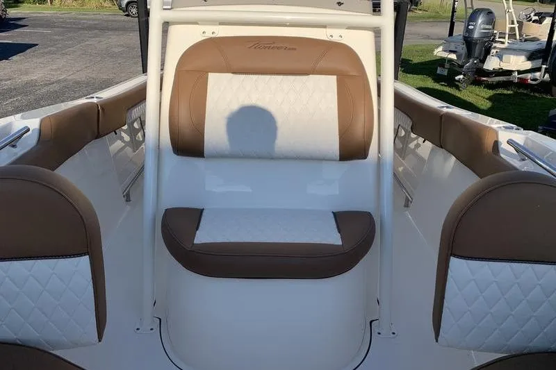 Slide: The Image of 2026 Pioneer ISLANDER 202 boat interior with brown and white seating. - 26