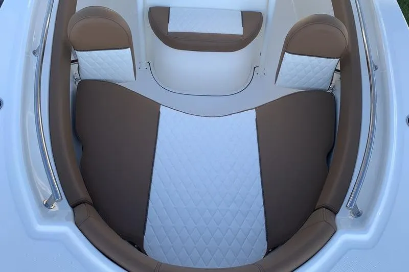 Slide: The Image of 2026 Pioneer ISLANDER 202 boat interior with brown and white cushioned seating. - 28