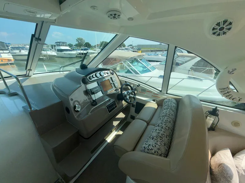 Slide: The Image of Interior of 2009 Cruisers Yachts 420 Coupe with helm and marina view. - 12