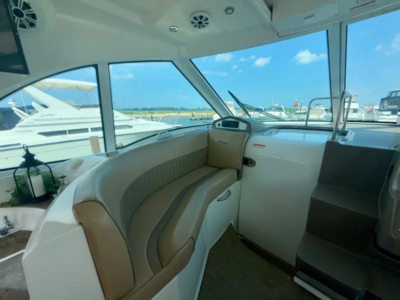 Slide: The Image of Interior of a 2009 Cruisers Yachts 420 Coupe with seating and marina view. - 13