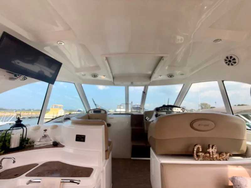 Slide: The Image of Interior of 2009 Cruisers Yachts 420 Coupe with helm, seating, and decor. - 14