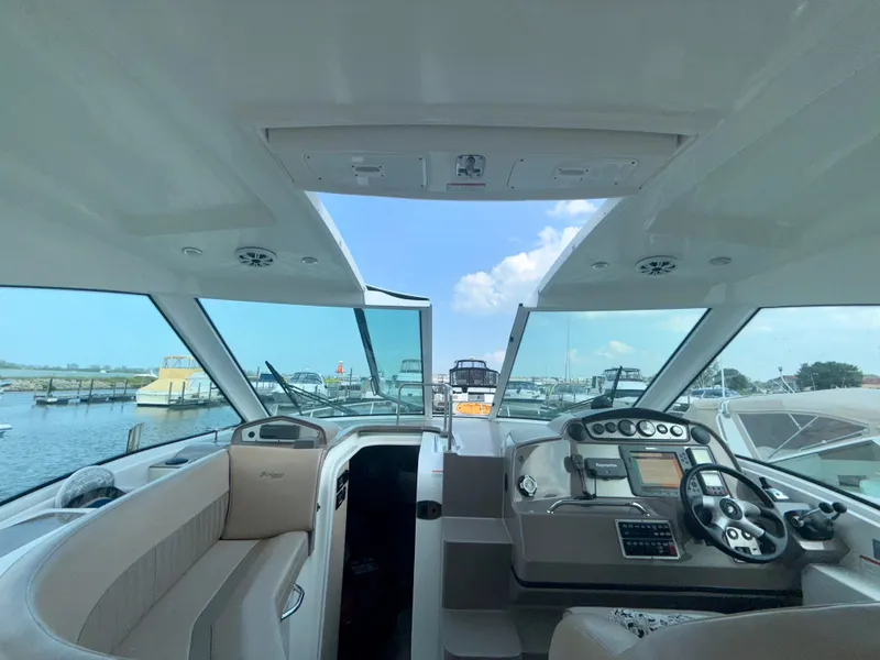 Slide: The Image of Interior view of 2009 Cruisers Yachts 420 Coupe, featuring helm and seating area. - 15