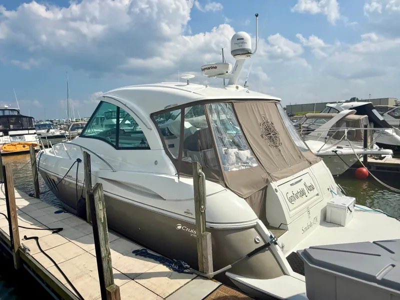 Slide: The Image of 2009 Cruisers Yachts 420 Coupe docked at marina under blue sky. - 2
