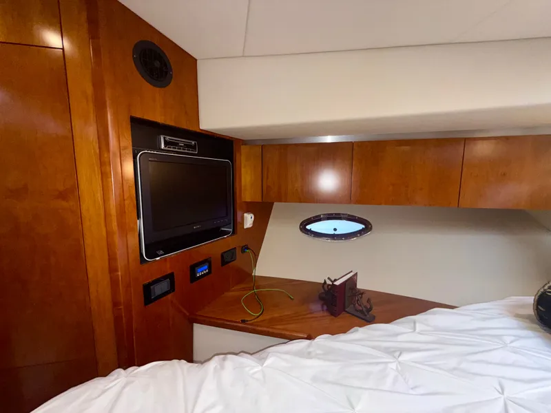 Slide: The Image of Interior cabin of 2009 Cruisers Yachts 420 Coupe with wood paneling and TV. - 29