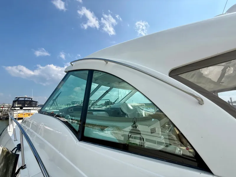 Slide: The Image of 2009 Cruisers Yachts 420 Coupe docked under a clear blue sky. - 3