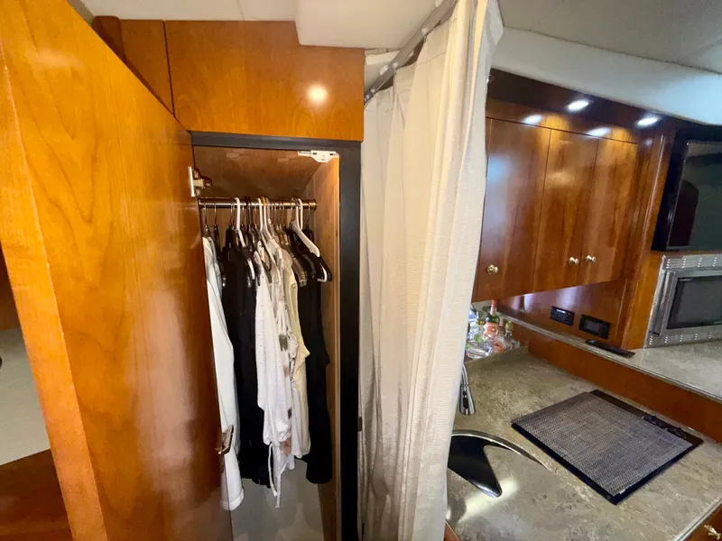 Slide: The Image of Interior of 2009 Cruisers Yachts 420 Coupe with wooden cabinetry and open closet. - 30