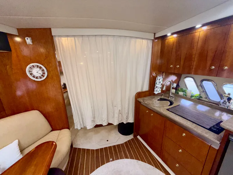 Slide: The Image of Luxurious 2009 Cruisers Yachts 420 Coupe interior with elegant wood cabinetry and modern amenities. - 31