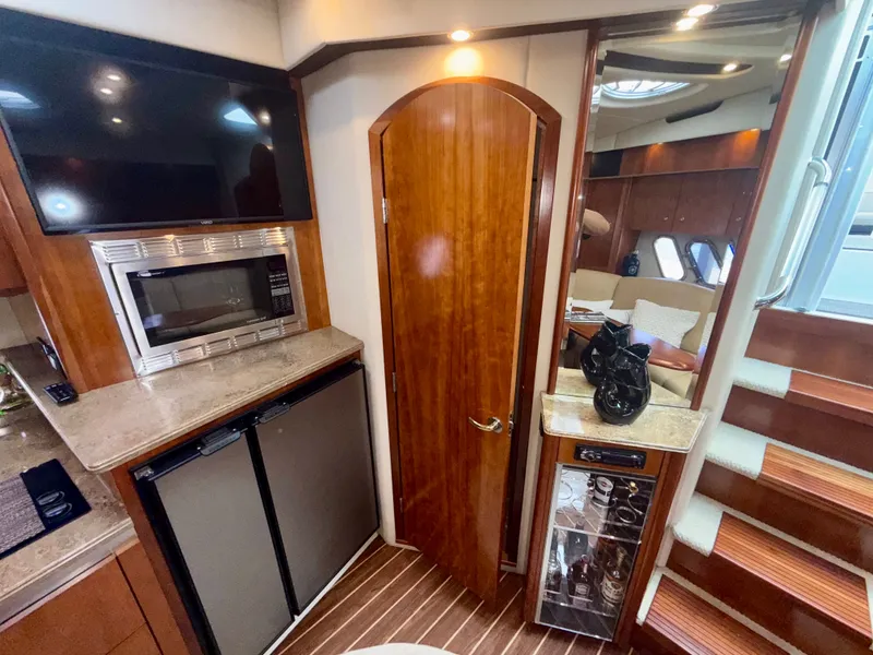 Slide: The Image of Luxurious interior of 2009 Cruisers Yachts 420 Coupe with modern amenities and elegant wood finishes. - 33
