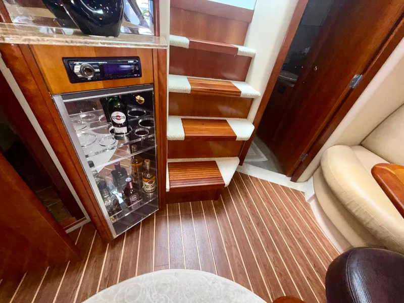 Slide: The Image of Luxurious interior of 2009 Cruisers Yachts 420 Coupe with wooden stairs and bar cabinet. - 34