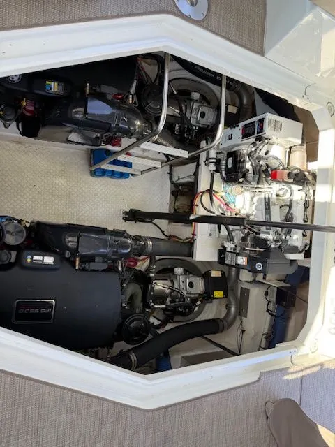 Slide: The Image of Engine compartment of 2009 Cruisers Yachts 420 Coupe, showcasing mechanical components and wiring. - 43