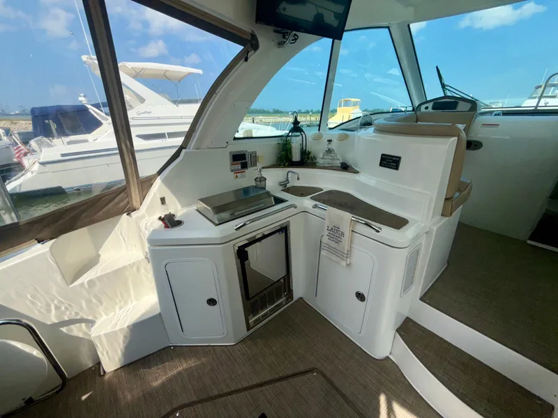 Slide: The Image of Interior of 2009 Cruisers Yachts 420 Coupe with kitchenette and seating area. - 8