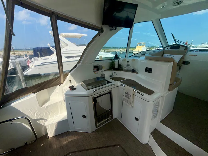 Slide: The Image of 2009 Cruisers Yachts 420 Coupe interior with kitchenette and seating area. - 9