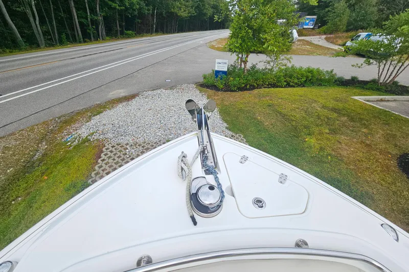 Slide: The Image of Bow view of 2019 Boston Whaler 230 Outrage near a road and greenery. - 15