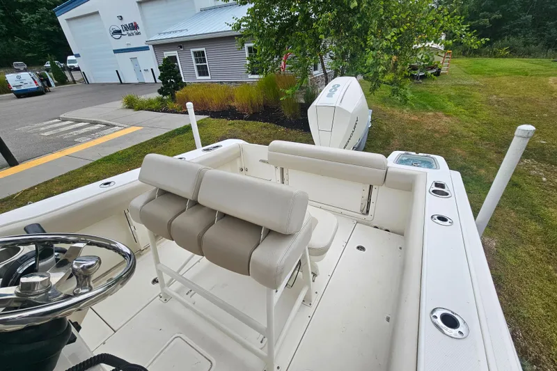 Slide: The Image of 2019 Boston Whaler 230 Outrage boat interior with seating and steering wheel. - 17
