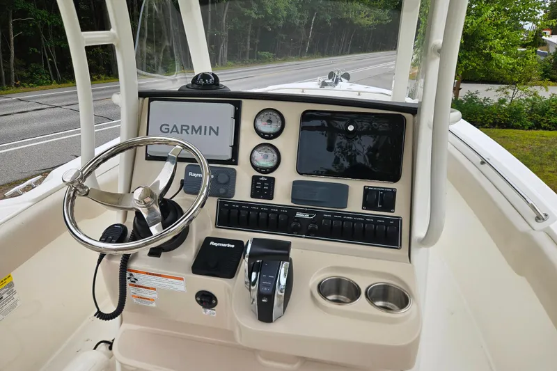 Slide: The Image of 2019 Boston Whaler 230 Outrage boat dashboard with Garmin navigation system and controls. - 19