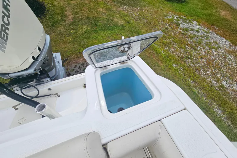 Slide: The Image of 2019 Boston Whaler 230 Outrage boat with open storage compartment and Mercury engine. - 6